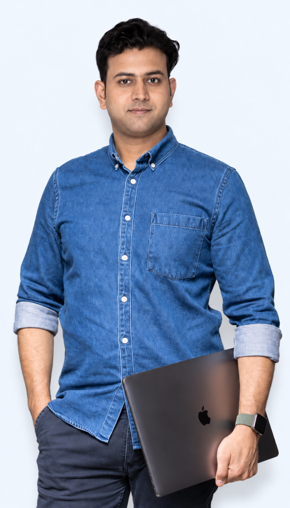 Portrait of a man in a blue shirt holding a laptop